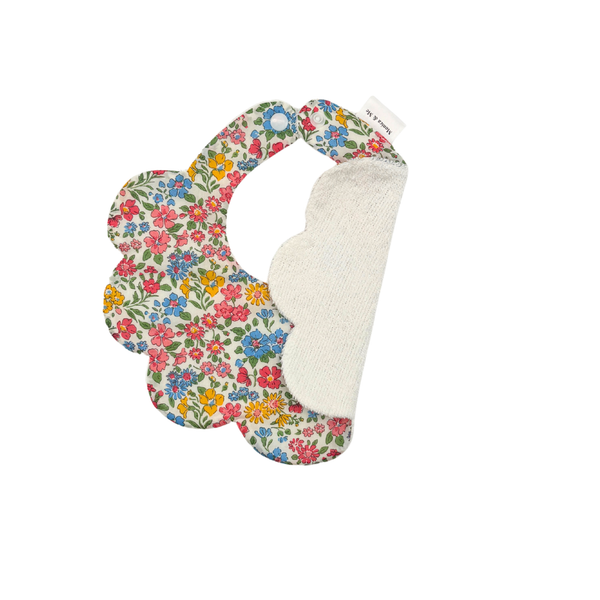 Pink, blue and yellow floral scalloped baby bib, Annabella S, close-up of the print