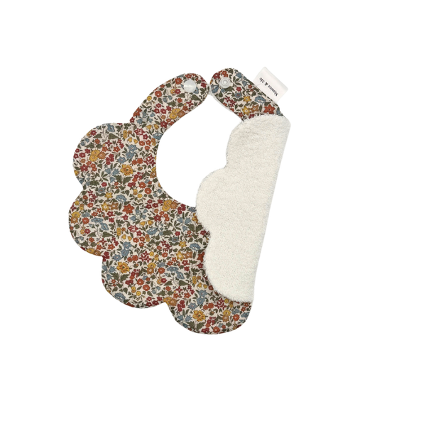 Small floral scalloped baby bib in neutral tones, Ava A, close-up of the print