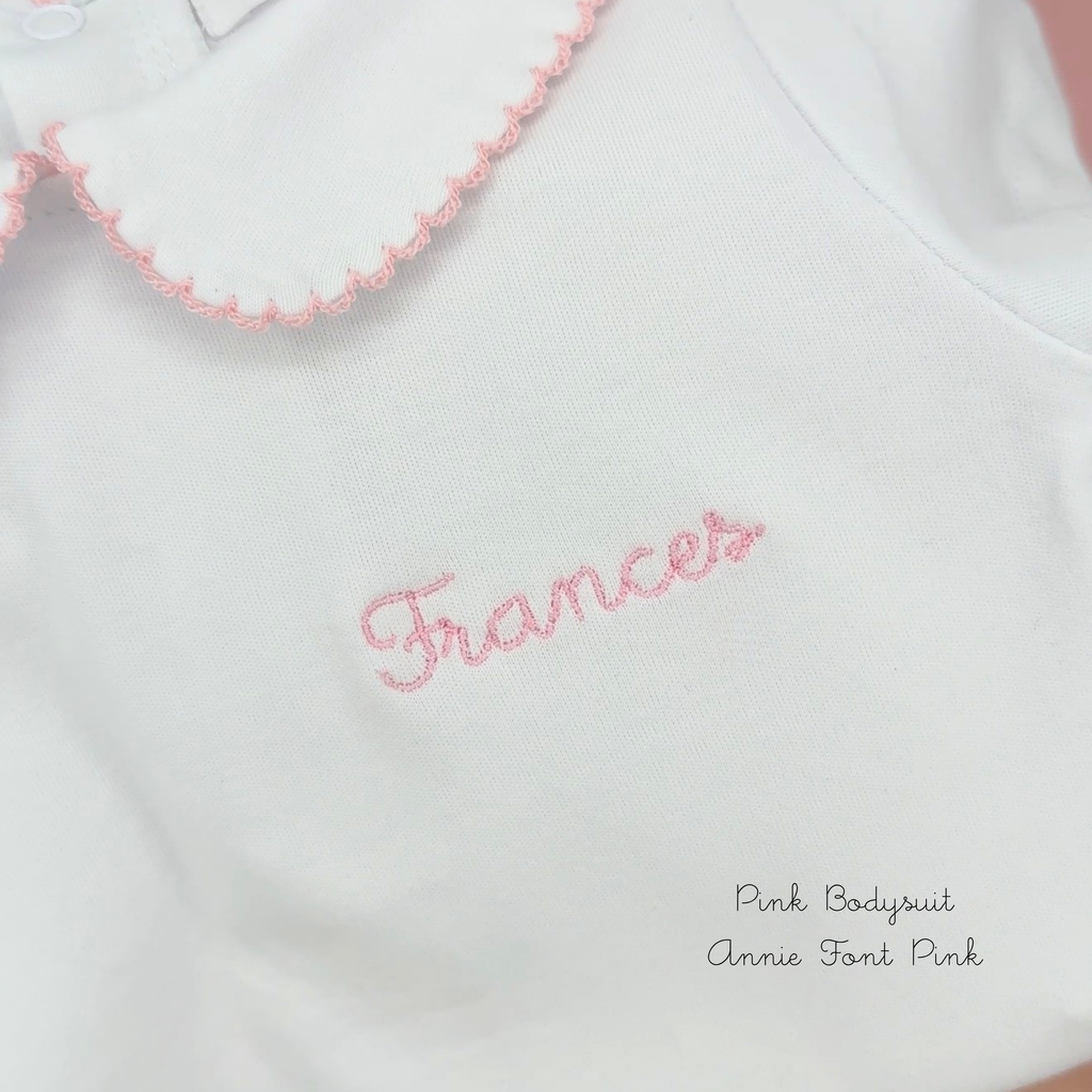 Peter Pan collar baby bodysuit shown with personalised name embroidery