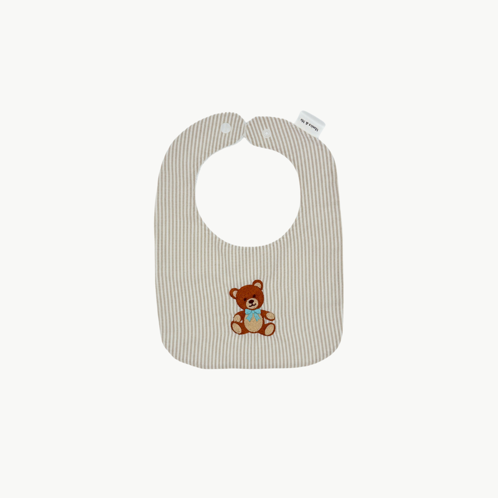 Striped baby bib with teddy bear design on a white background